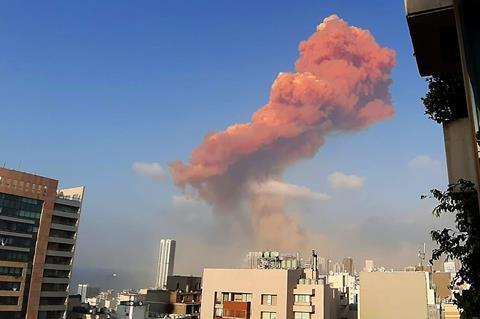 A photo of reddish-brown smoke rising above a city