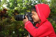 A young boy (young scientist) taking a photograph