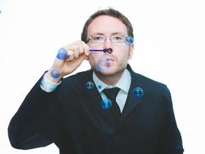 A man blowing coloured bubbles