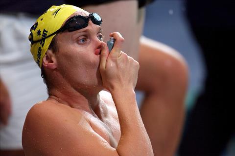A swimmer using an asthma inhaler
