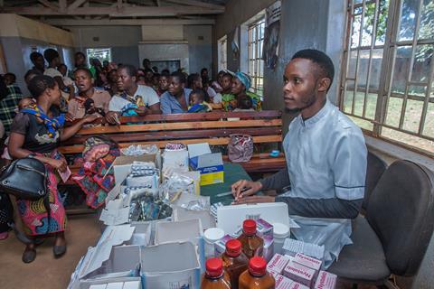 An image showing a nurse waiting to administer Malaria vaccine