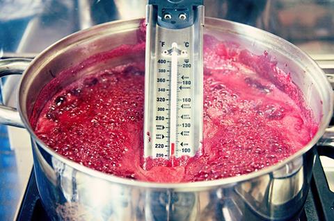 Boiling jam and thermometer in a saucepan