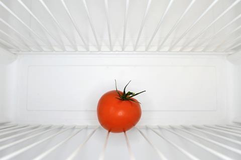 A tomato in a fridge