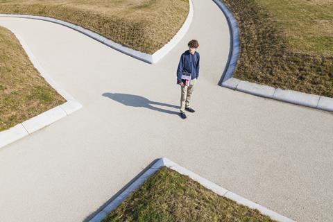 An image showing a student at a crossroads