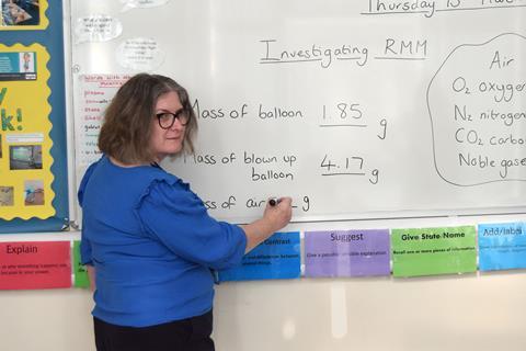 A teacher in front of a white board