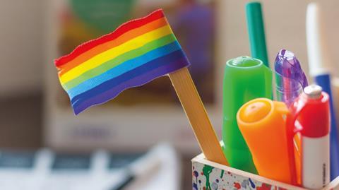 An image showing a LGBT mini flag inside pot of stationery