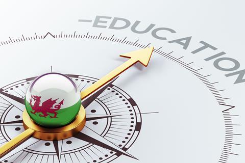 A digital illustration of a compass with a Welsh flag point to the word Education