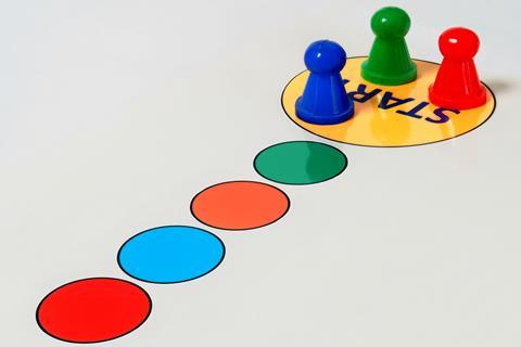A photo of three board game pieces at the start of the game