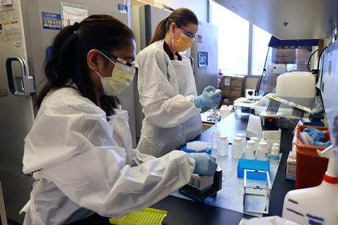 A photo of two scientists working in a lab