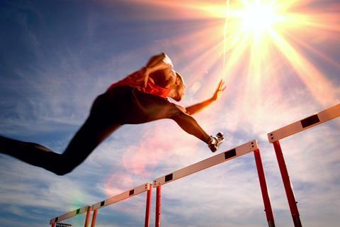 An image of a man jumping a hurdle