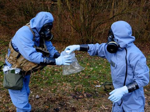 An image showing OPCW inspectors collecting samples during a mock inspection exercise