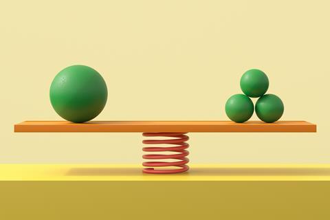 An image showing a balance with one big green ball on one side and three green smaller balls on the other