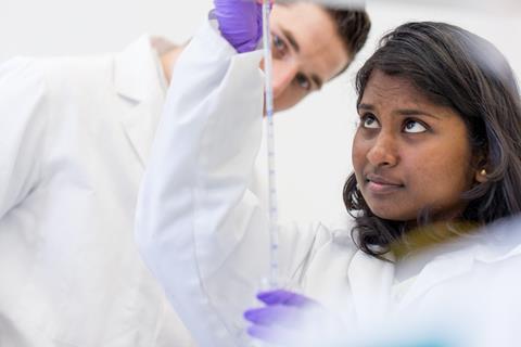 An image showing a male and a female student working together on a practical