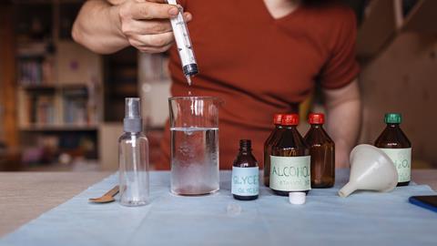 An image showing a man making hand sanitiser at home 