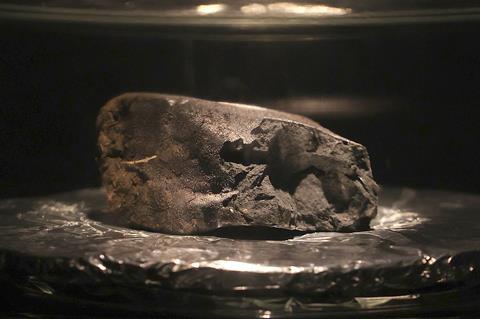 A photo of a rock on display in a museum