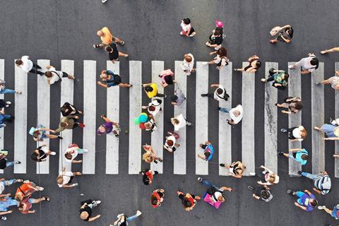An overhead photo of people crossing the road in different directions