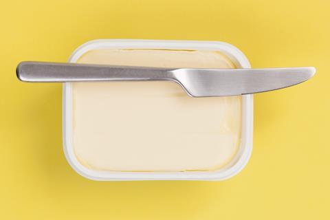 A tub of butter with a knife