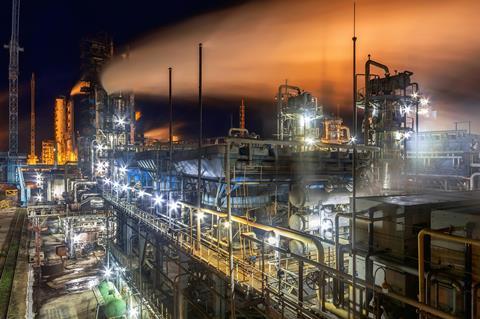 A photo of an industrial factory at night