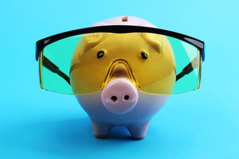 A piggy bank wearing protective goggles