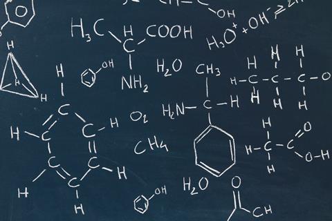 A picture showing a blackboard with chemical formulas written in white chalk