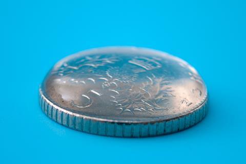 A drop of water balanced on a five-pence piece