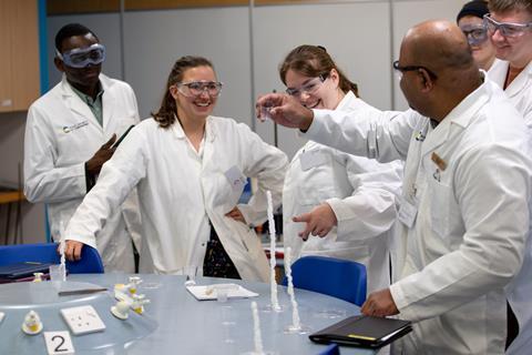 Student science teacher watch a trainer give a demonstration