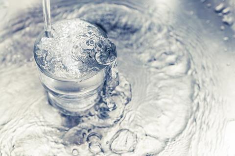 Water pouring into a drinking glass