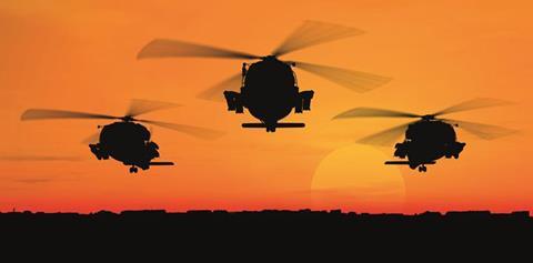 helicopters flying against the sunset 