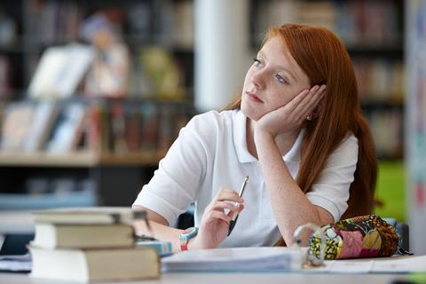 A high school student daydreaming in class