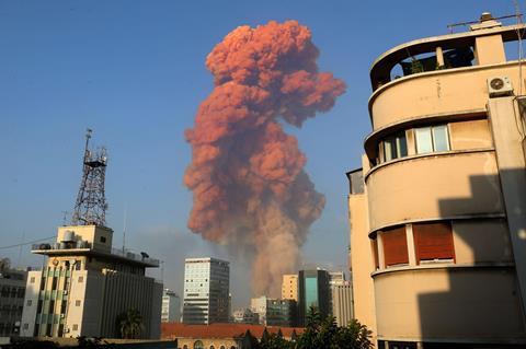 A photo of reddish-brown smoke rising above a city