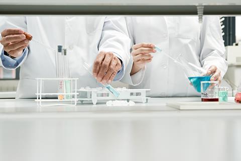 A photo of the hands of male and female scientists working together 