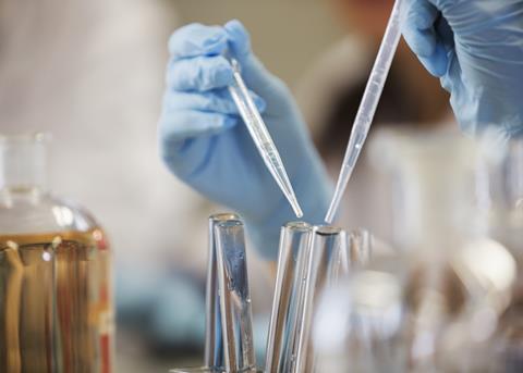 An image showing a student using pipettes 