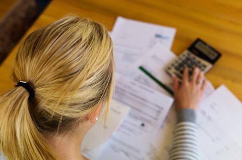 Woman with finance forms and calculator