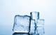 A close-up photograph of an ice cube melting against a neutral background with three more ice cubes visible behind it
