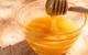 picture of honey in a bowl with a wooden dipper