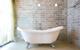 A bath tub in a brick room