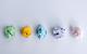 Five different coloured pieces of paper crumpled into balls