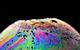 A close-up photograph of the surface of a soap bubble, multi-coloured against a black background