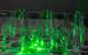 Green laser shone through tumbler glasses that reflect the light