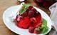 picture of a red jelly on a plate with raspberries on the top