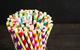 lots of colourful stripy paper straws in a jar