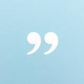 White paper cutout quotation marks against a blue background