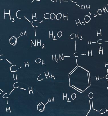 A picture showing a blackboard with chemical formulas written in white chalk