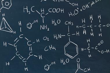 A picture showing a blackboard with chemical formulas written in white chalk