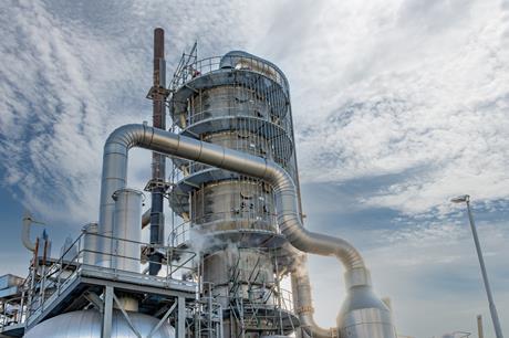 A fractional distillation tower with metal pipes an steam