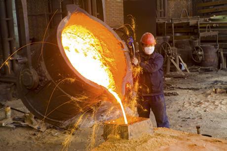 Man pouring molten metal into cast