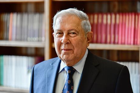 Yusuf Hamied pictured in front of a bookcase